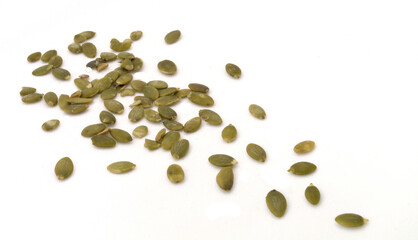 Pumpkin seeds scattered on white background