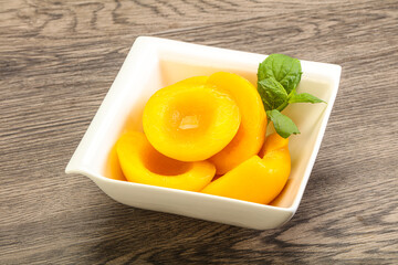 Sweet ripe canned peaches with mint