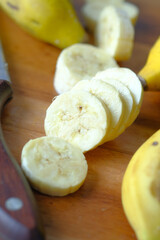 slice of banana banana on chopping board on table .