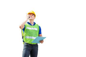 Factory worker in hardhat and safety vest talks on two-way radio, man with clipping path on white background