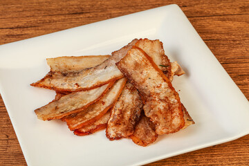 Roasted juicy bacon in the plate