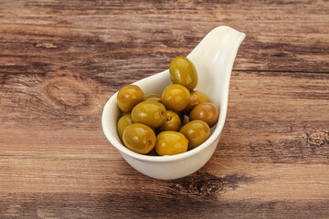 Green pickled olives in the bowl
