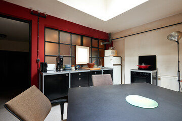 Modern kitchen furniture in grungy loft view from front.