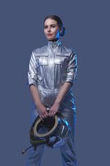 Female space explorer in spacesuit holding helmet © Fxquadro