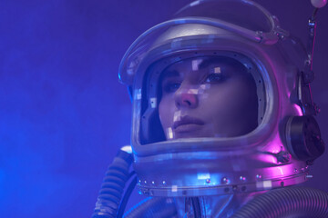 Headshot of spacewoman with helmet in fog