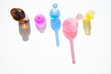 Glass bottle assortment with colorful shadows