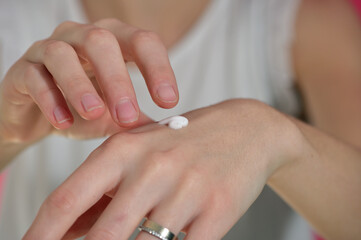 Woman applying moisturize cream on hands