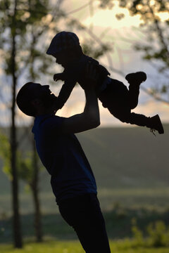 Father playing with his son in forest