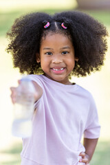 Concept of childhood and drinking water on a hot day.