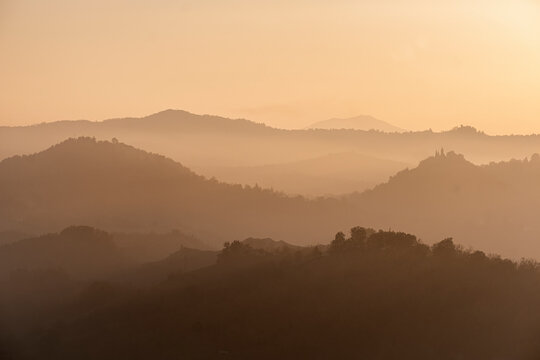 Sunset light reflected in the mist on countryside hills, Emilia Romagna, Italy