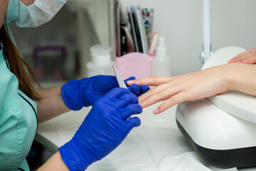 Woman getting nail manicure.