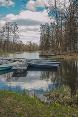 Fototapeta premium Blue boats on the river bank in Gatchina park