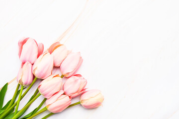 Obraz na płótnie Canvas Pink tulips bouquet on a white marble background. Valentines Day, Mothers Day, bachelorette celebration concept