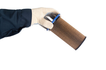 An auto mechanic holds an old dirty fuel filter in his hand. Fuel filter replacement concept, low-quality fuel, white background, isolate