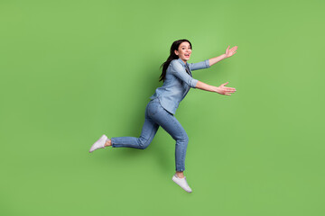 Fototapeta na wymiar Full size profile photo of funny brown hairdo lady run wear jeans shirt sneakers isolated on pastel green color background