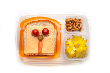 School lunch box snacks for kids over white background. Back to school. Healthy and fun snacks option for parents. Cute food art creative concepts. Bows with fruits and vegetables and cute sandwich.