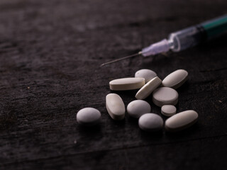Fototapeta na wymiar Syringe with medicine pill on textured background stock image.