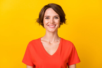 Photo of optimistic nice brunette lady wear orange t-shirt isolated on vibrant yellow color background