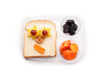 School lunch box snacks for kids over white background. Back to school. Healthy and fun snacks option for parents. Cute food art creative concepts. Bows with fruits and vegetables and cute sandwich.