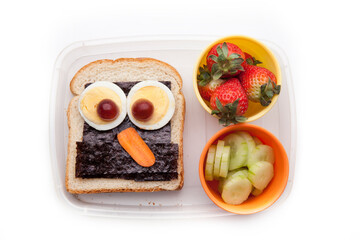 School lunch box snacks for kids over white background. Back to school. Healthy and fun snacks...