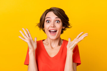 Portrait of impressed positive lady raise hands palms up open mouth cant believe isolated on yellow...