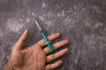 Side effects of steroid with syringe and human hand on textured background stock image.