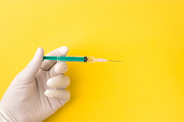 Syringe on doctor's hand wearing white gloves stock image.