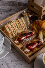 full breakfast with coffee, toast, croissants ready to eat