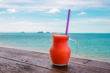 Cocktails or juice from fresh tropical fruits on the background of the sea.