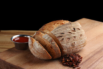 bread on wood background close up. wholegrain bread on wooden background. and tomatoes sauce