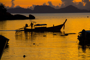 Longtail boat on the sea at sunrise in Adang-Ravi Islandsin,Tarutao National Park, Satun Thailand.