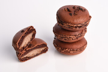 Brown macaroon with filling on a white background.