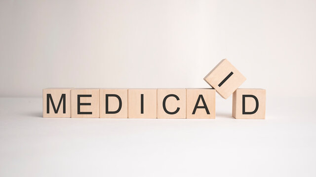 The word medicaid is written on wooden cubes on a light background. Business concept