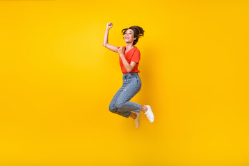 Full size profile photo of hooray brunette short hairdo lady jump wear t-shirt jeans sneakers isolated on yellow color background