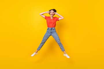 Fototapeta na wymiar Full size portrait of excited cheerful person fingers show v-sign near eyes isolated on yellow color background