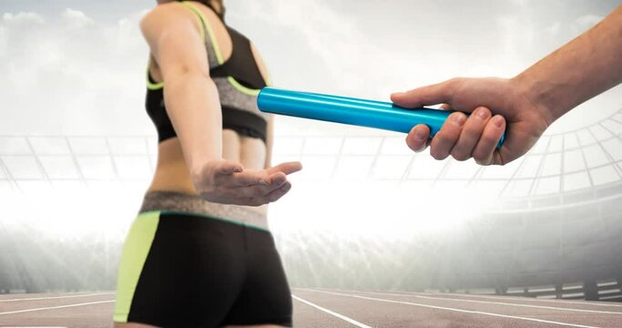 Animation of athlete's hands passing relay baton over sports stadium