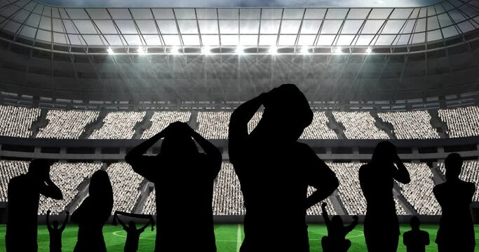 Animation of silhouettes of disappointed sports fans over sports stadium