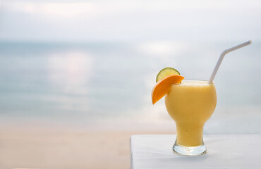 Cocktails or juice from fresh tropical fruits on the background of the sea.