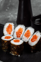 Simple maki with fresh salmon. Sushi on a gray background