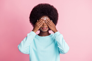 Photo portrait of girl closed eyes with hands wearing blue shirt isolated on pastel pink color background