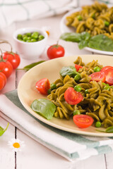 Fusilli pasta with cherry tomatoes and peas.