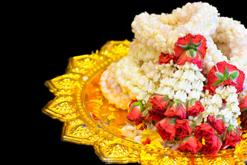 Jasmine garland in Gold tray on black background