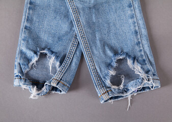 Torn blue jeans. Fashion concept.