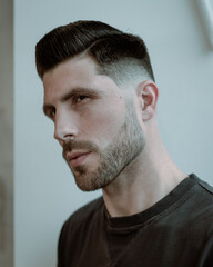 Obraz premium portrait of a man with stylish haircut on the white wall background