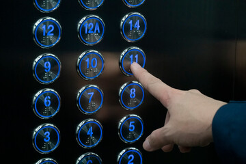 Hand push the elevator button 11th floor