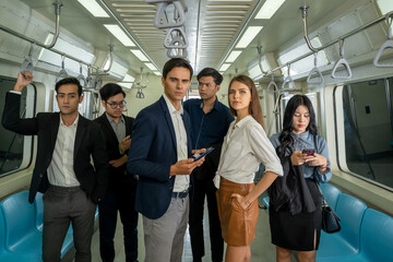Obraz premium Business people and office worker with smartphone in subway while traveling to work passengers traveling concept.