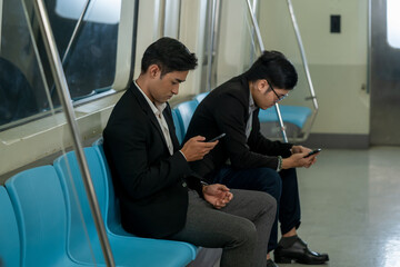 Business People passenger using smartphone in the subway while traveling to work during rush hours.