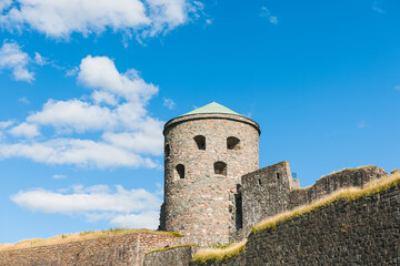 Fototapeta na wymiar Old fortress tower against blue sky
