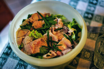 Healthy lunch in a plastic tray.
Salad with ham, chives and spices. Low carbohydrates and lots of proteins and fibers.