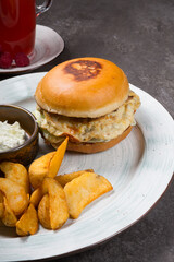 Burger with fried egg omelette served potatoes
